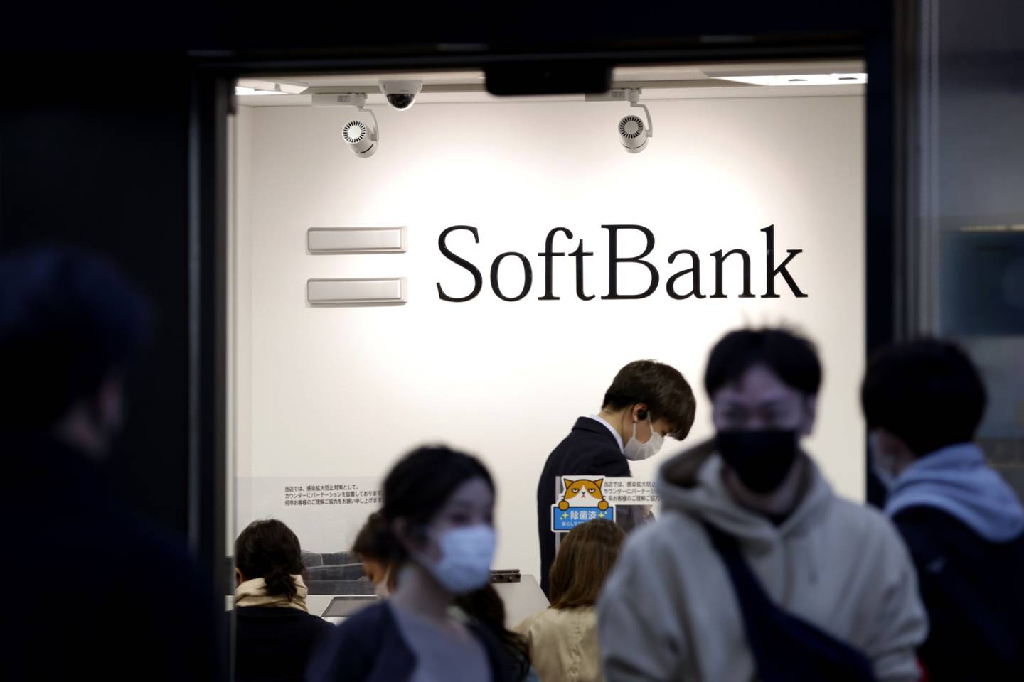 The SoftBank Corp. logo displayed inside a store in Tokyo, Japan, on Sunday, Nov. 7, 2021. SoftBank Group Corp. might see a return to investment losses when it reports earnings on Monday, as the impact of Chinas regulatory crackdown begins to hit valuations in its Vision Fund portfolio. Photographer: Kiyoshi Ota/Bloomberg