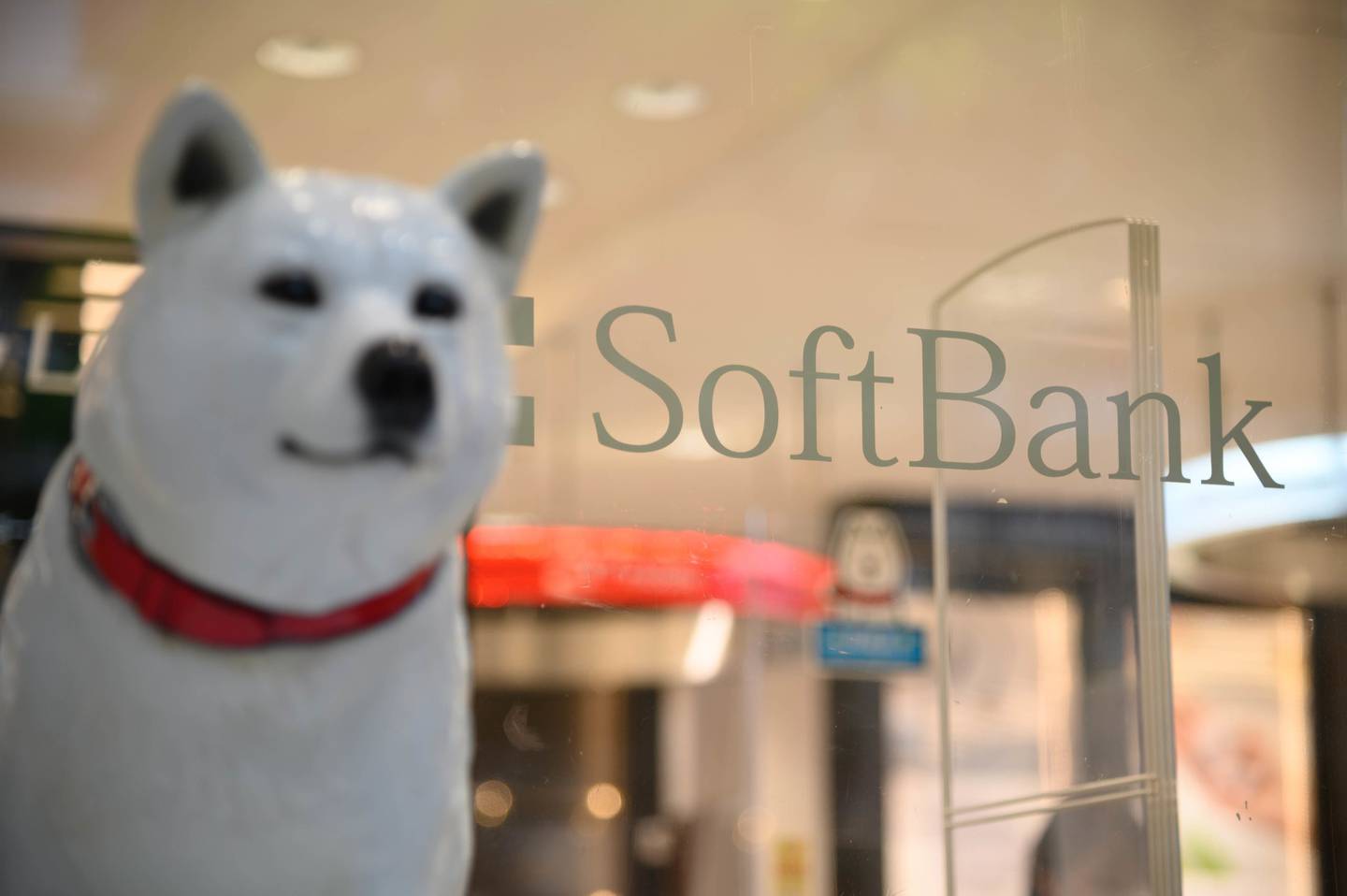 A statue of the 'Oto-san' mascot in front of a SoftBank Corp. store in Tokyo, Japan.