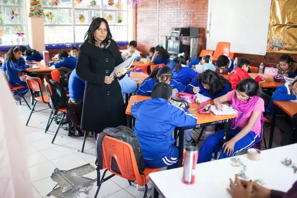 Marlene Guerra, principal of the Ingeniero Miguel Bernard primary school, stands for a photograph in a classroom at the school on the southern outskirts of Mexico City, Mexico, on Friday, Dec. 11, 2015. To fix its crumbling schools, Mexico is turning to bond investors. The money that will pay for the repairs will come from Mexico's first-ever education infrastructure debt sale. Photographer: Brett Gundlock/Bloomberg *** Local Caption *** Marlene Guerra