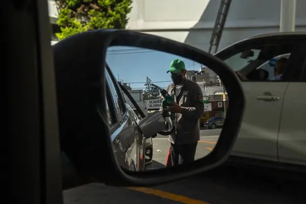 Un dependiente atiende la recarga de combustibles a un vehículo en una gasolinera con la marca de la empresa estatal Petróleos Mexicanos (Pemex)  en la Ciudad de México.