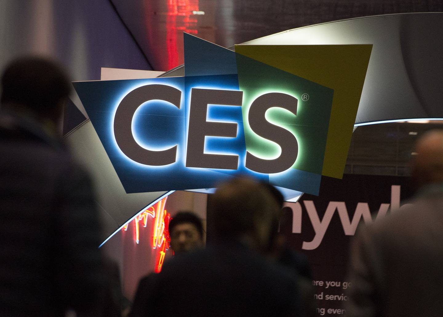 Attendees walk past signage during CES 2020 in Las Vegas, Nevada, U.S., on Wednesday, Jan. 8, 2020.