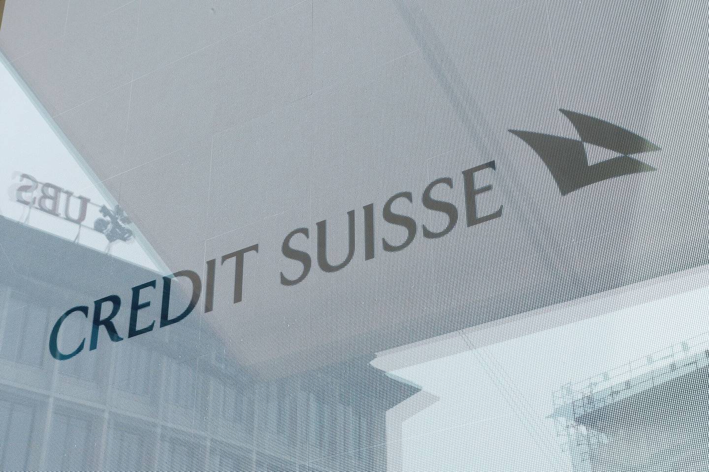 Signage in the window of the Credit Suisse Group AG headquarters in Zurich, Switzerland, on Tuesday, March 21, 2023. Recruiters across the world are getting an unprecedented flood of calls from?Credit Suisse bankers seeking new jobs as the embattled Swiss lender is set to be taken over by?UBS Group AG.dfd