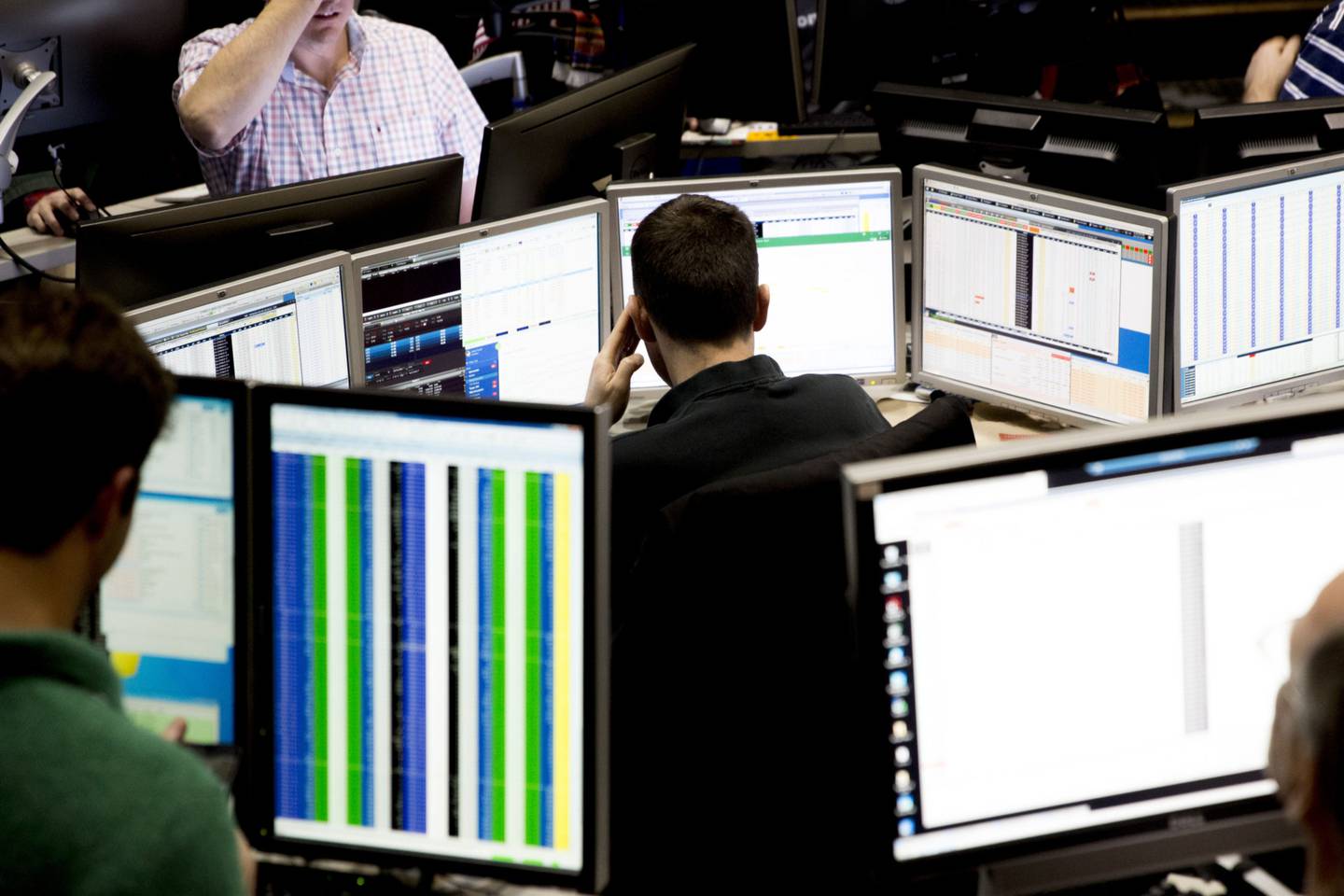 A trader looks over computer monitors as he works in the Cboe Volatility Index (VIX) pit on the floor of the Cboe Global Markets, Inc. exchange in Chicago, Illinois, U.S., on Wednesday, Feb. 14, 2018. Signs of an inflation pickup have roiled financial markets this month, and stock futures tumbled early Wednesday on concern the Fed would quicken its pace of tightening following data that showed faster-than-forecast inflation. Those fears receded as investors digested a separate report showing weak retail sales that raised questions about the economys strength.