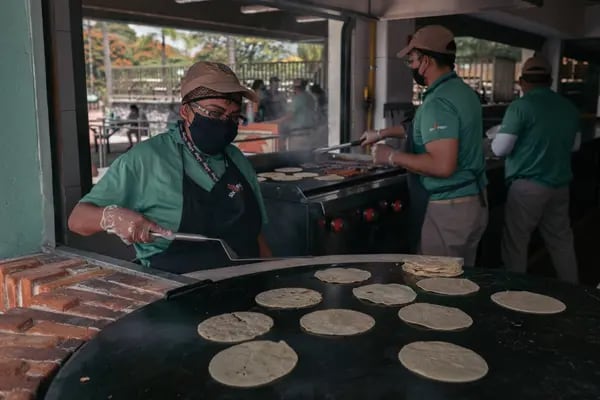 Workers wearing protective masks prepare food in a restaurant at the Six Flags Hurricane Harbor water park in Oaxtepec, Morelos state, Mexico, on Saturday, Sept. 12, 2020. Mexico reported 5,674 new Covid-19 cases, bringing the total to 663,973, according to data released by the Health Ministry Saturday night. Photographer: Jeoffrey Guillemard/Bloomberg