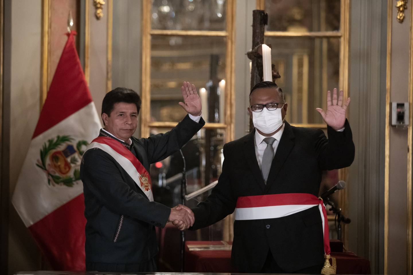 Pedro Castillo, Peru's president, left, shakes hands with Hernan Yuri Condori Machado, Peru's new minister of health, during a swearing-in ceremony at the Government Palace in Lima, Peru, on Tuesday, Feb. 8, 2022. Castillo has repeatedly made changes to his cabinet since taking office, including naming his fourth prime minister in just over six months as he tries to restore stability after weeks of political turmoil. Photographer: Angela Ponce/Bloomberg