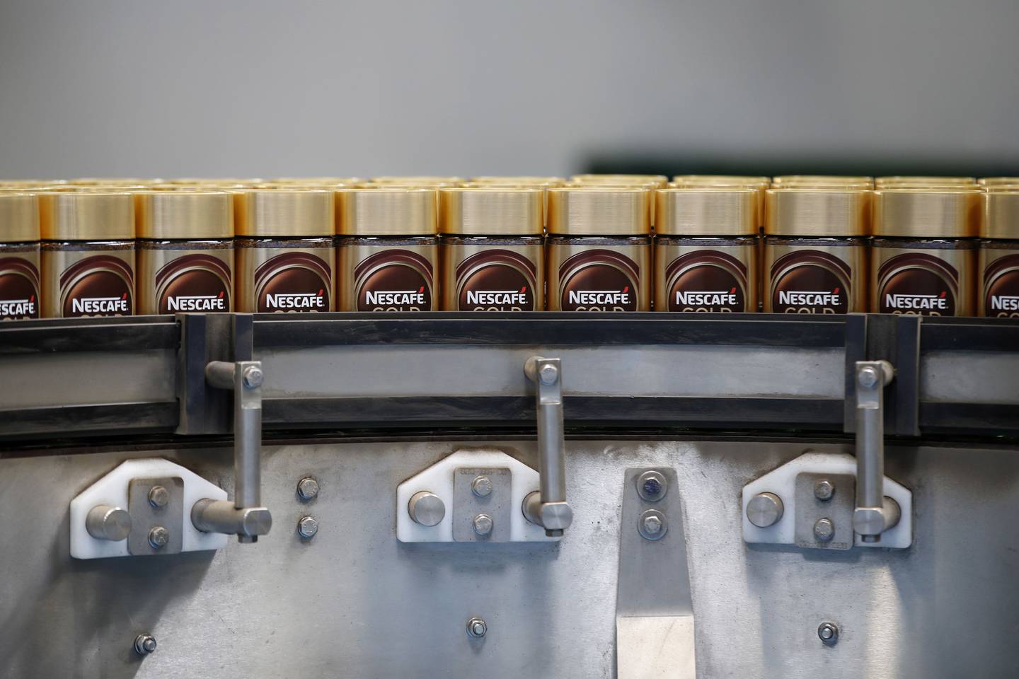 Jars of Nescafe Gold instant coffee granules move along the production line at Nestle SA's Nescafe plant in Orbe, Switzerland, on Thursday, May 20, 2021. Nestle SA sales grew at more than twice the rate analysts expected as the Swiss food giant sold more Nespresso capsules to people working from home and restaurants in Asia stocked up as they started reopening. Photographer: Stefan Wermuth/Bloomberg