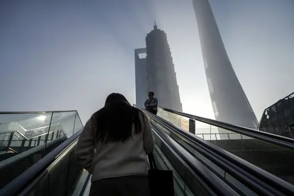 Pedestrians ride escalators in Pudong's Lujiazui Financial District in Shanghai, China, on Tuesday, Jan. 9, 2024. China's stock market suffers from a lack of positive drivers as the new year begins, and Beijing's support efforts are likely to keep falling flat amid persistent risks. Photographer: Qilai Shen/Bloomberg