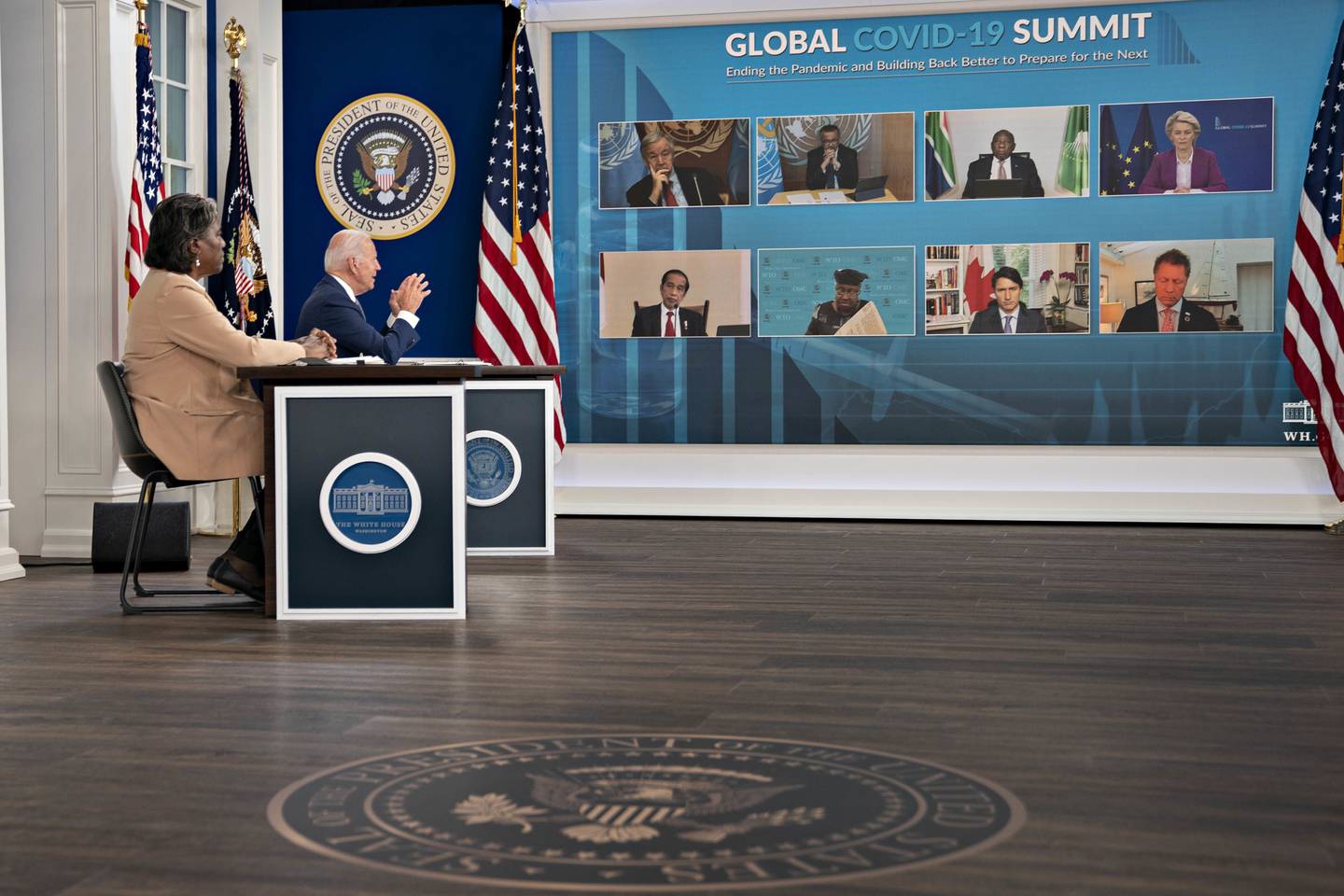 U.S. President Joe Biden, second left, speaks as participants including Linda Thomas-Greenfield, U.S. ambassador to the United Nations (UN), left, listen during a virtual Covid-19 Summit on the sidelines of the United Nations General Assembly in the Eisenhower Executive Office Building in Washington, D.C., U.S., on Wednesday, Sept. 22, 2021. Biden is calling for 70% of the world to be vaccinated by this time next year during the summit that's intended to spur countries, businesses and organizations to set firm targets to defeat the coronavirus pandemic. Photographer: Andrew Harrer/Bloomberg