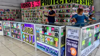 Workers at a cellphone accessories shop that takes accepts Bitcoin as a payment method in the Historical Center of San Salvador,