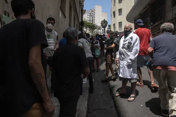 Robin Mendoca, president of the Sao Paulo chapter of State Movement for the Homeless Population (MEPSR), center right, oversees food donations in Sao Paulo, Brazil, on Tuesday, Oct. 26, 2021.