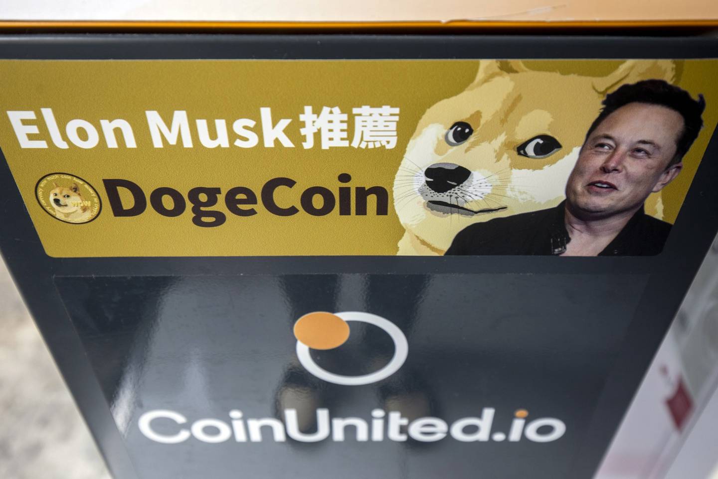 A sticker advertising Dogecoin on a cryptocurrency automated teller machine (ATM) at a laundromat in Hong Kong.