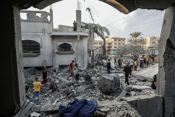 Varias personas buscan entre edificios destruidos durante ataques aéreos israelíes en Jan Yunis, Gaza, el 13 de noviembre.