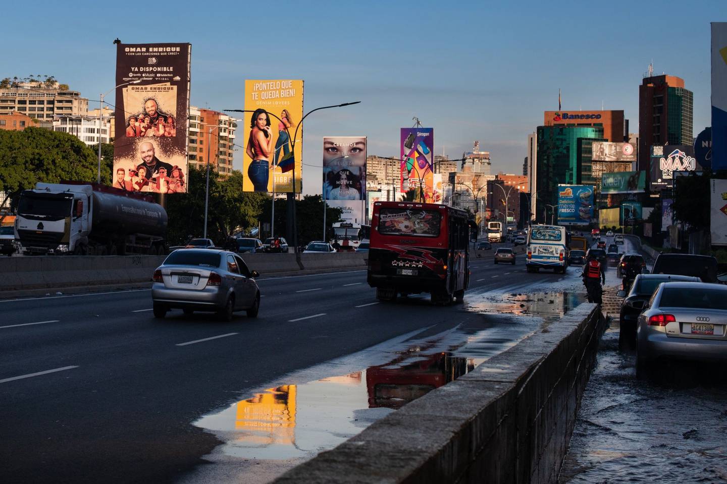 Publicity for music concerts, home appliances and taxi apps line the main highway in Caracas. Photographer: Gaby Oraa/Bloombergdfd