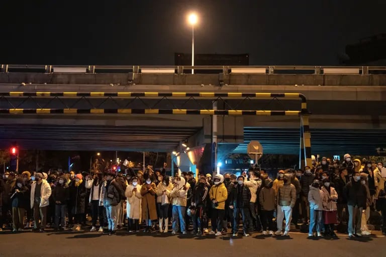 Onlookers stand by the road during a protest in Beijing, in November last year. Source: Bloombergdfd