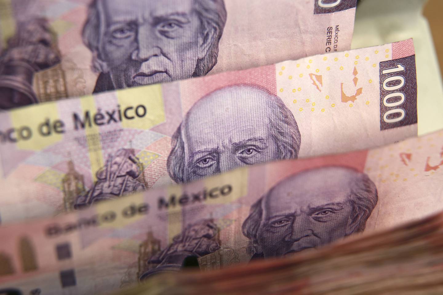 Mexican one thousand pesos bills are run through a counting machine