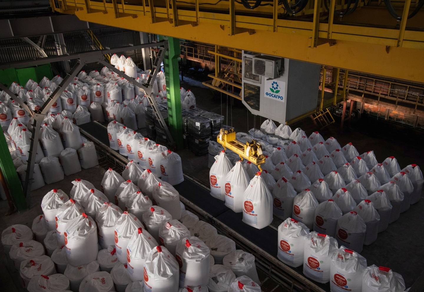 A worker operates a crane to lift sacks of Apaviva NPK(S) phosphate fertilizer at the PhosAgro-Cherepovets fertilizer plant, operated by PhosAgro PJSC, in Cherepovets, Russia, on Thursday, Dec. 2, 2021. Russia plans to impose a six-month quota on some fertilizer exports to safeguard local supplies and limit costs for farmers after the energy crisis sent nitrogen nutrient prices soaring. Photographer: Andrey Rudakov/Bloomberg