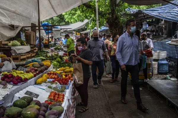 Shoppers browse stalls of fresh fruits and vegetables at a street market in the Ipanema neighborhood Rio de Janeiro, Brazil, on Friday, Feb. 11, 2022.