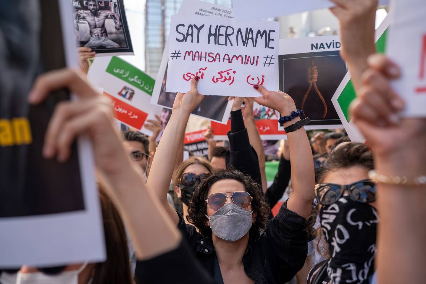 A protester wearing a face mask holds a placard reading 'Say Her Name' during a demonstration over the death of Mahsa Amini, outside the Iranian consulate building in Istanbul, Turkey, on Thursday, Sept. 29, 2022. Protesters in Iran and other countries are mobilizing to show their anger goes far beyond the tragic death of Amini, the 22-year-old woman who died in mid-September after being in the custody of the country's morality police. Photographer: Erhan Demirtas/Bloomberg