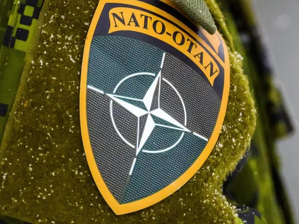 The NATO logo is seen on a uniform during the NATO annual military exercise "Winter Shield" 2021 in Adazi, Latvia. Photographer: Gints Ivuskans/AFP/Getty Images