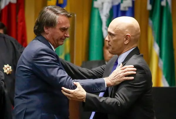 Jair Bolsonaro greets Alexandre de Moraes during an inauguration ceremony of new judges of the Superior Labor Court in Brasilia, on May 19, 2022.