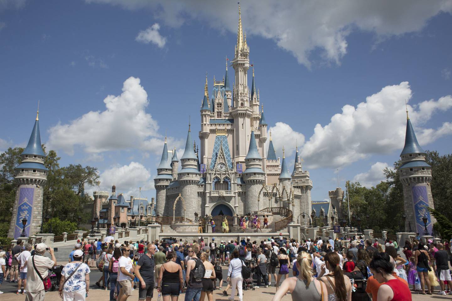 Visitors watch a performance at the Cinderella Castle at the Walt Disney Co. Magic Kingdom park in Orlando, Florida, U.S., on Tuesday, Sept. 12, 2017. The Walt Disney Co. Magic Kingdom park reopened to a smaller-than-usual crowd after closing for two days and suffering minor storm damage from Hurricane Irma.dfd