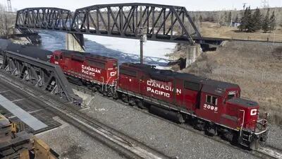 A Canadian Pacific Railway locomotive travels across a bridge in Calgary, Alberta, Canada.