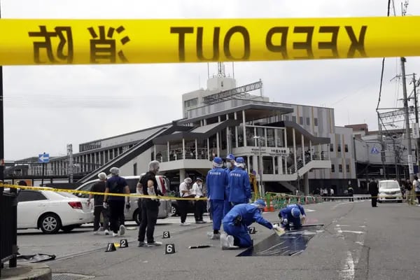 Police officers cordon off the spot where former Prime Minister of Japan Shinzo Abe was shot on July 8, 2022