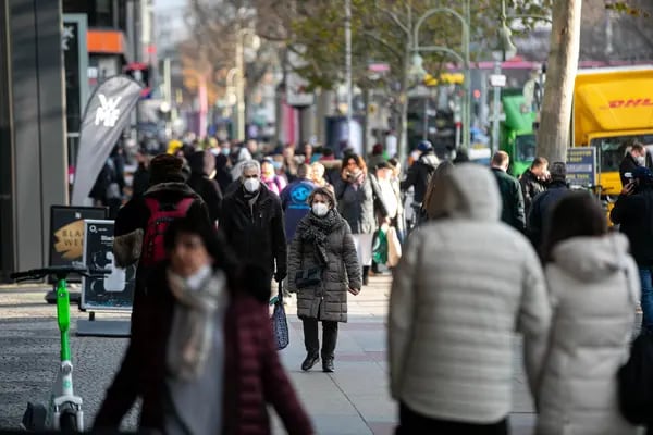 Shoppers wear protective face masks on Kurfrstendamm, in Berlin.