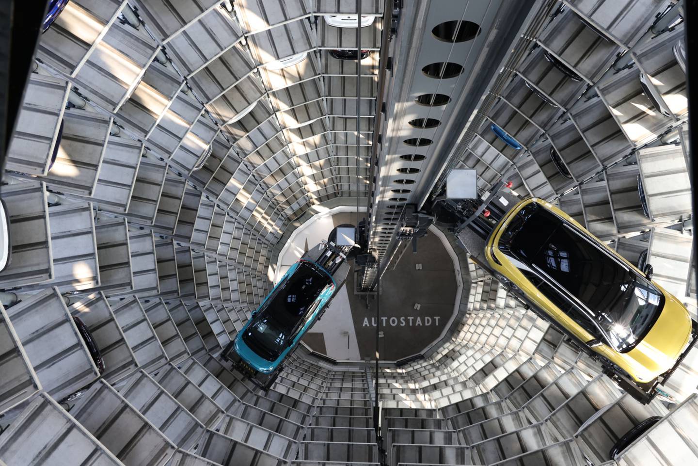 A VW ID.3, left, and ID.4 inside a delivery tower in Wolfsburg, Germany. Photographer: Liesa Johannssen-Koppitz/Bloombergdfd