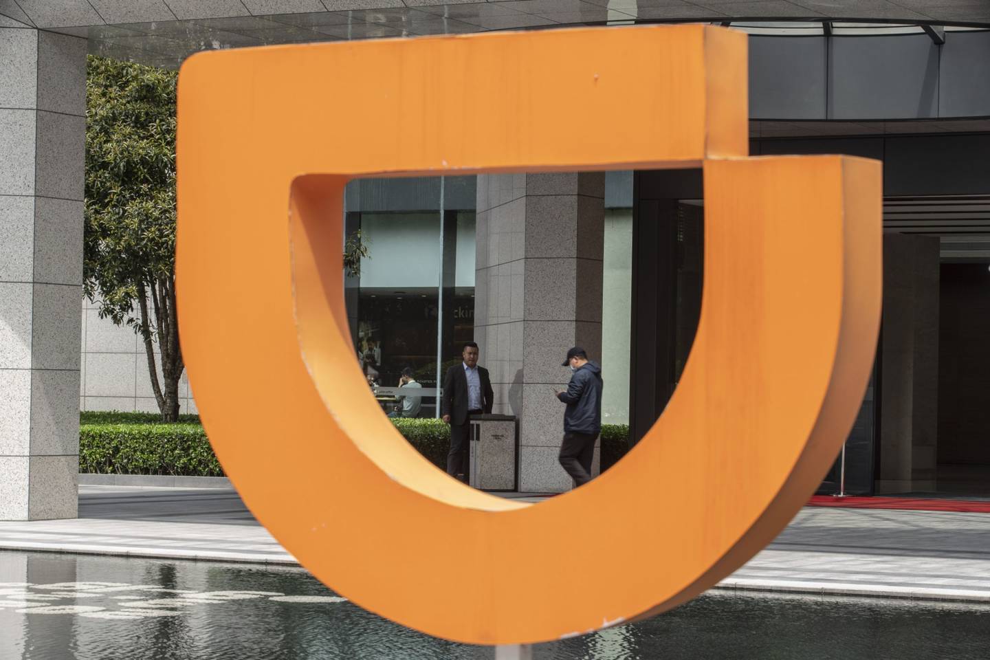 Signage outside the Didi Chuxing Technology Co. offices in Hangzhou, China, on Wednesday, March 24, 2021. Chinese ride-hailing giant Didi is accelerating plans for an initial public offering to as early as next quarter to capitalize on a post-pandemic turnaround, people familiar with its plans said. Photographer: Qilai Shen/Bloomberg
