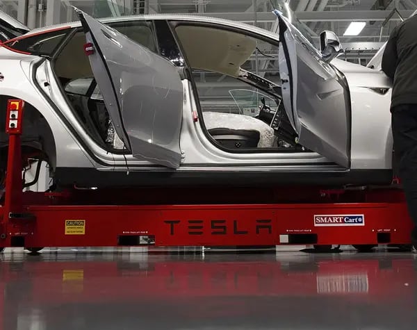Tesla Motor Inc. associates work on the Model S electric car at the company's factory in Fremont, California.