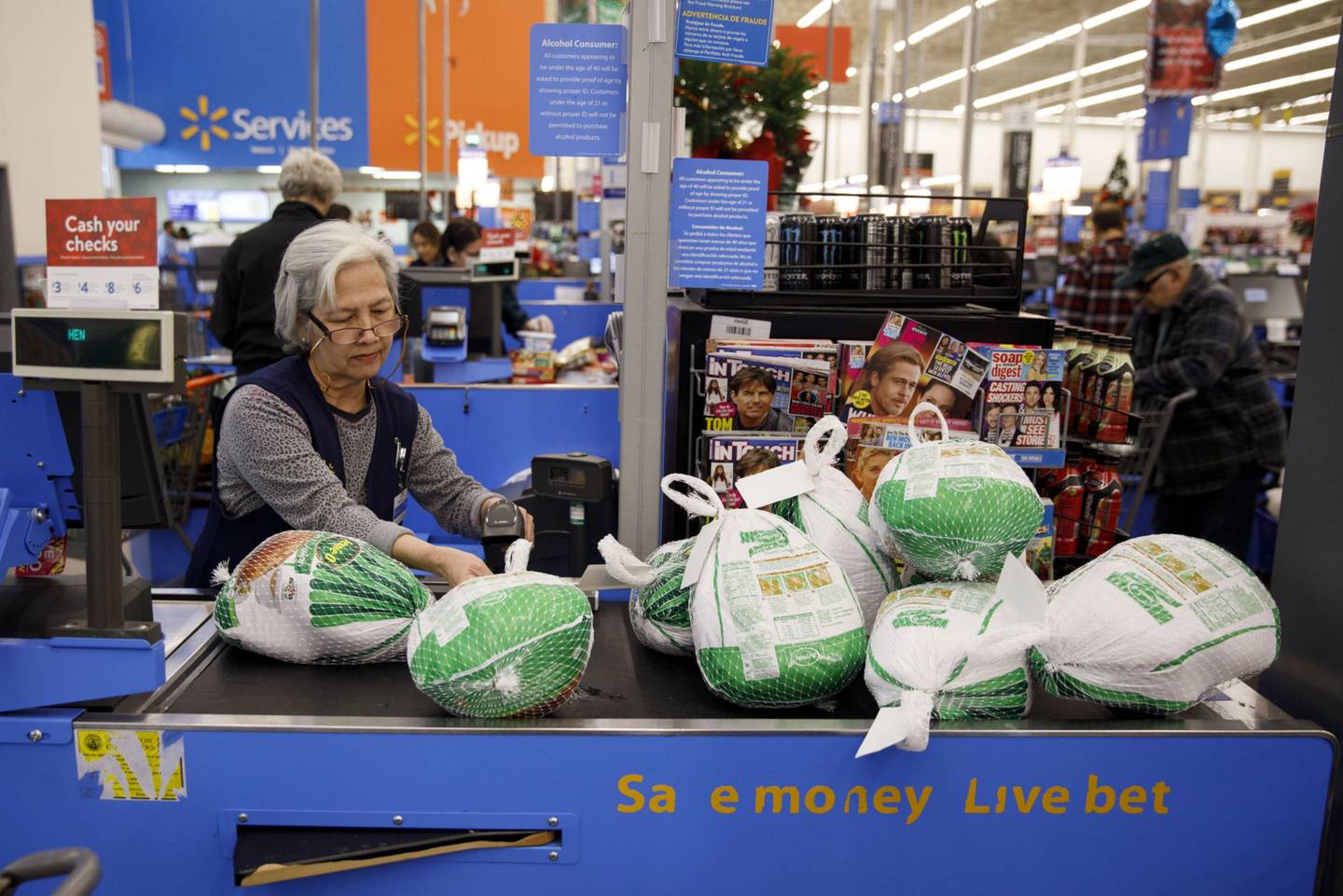 A cashier scans Jennie-O turkeys at a Walmart Inc. store in Burbank, California, U.S., on Tuesday, Nov. 26, 2019.