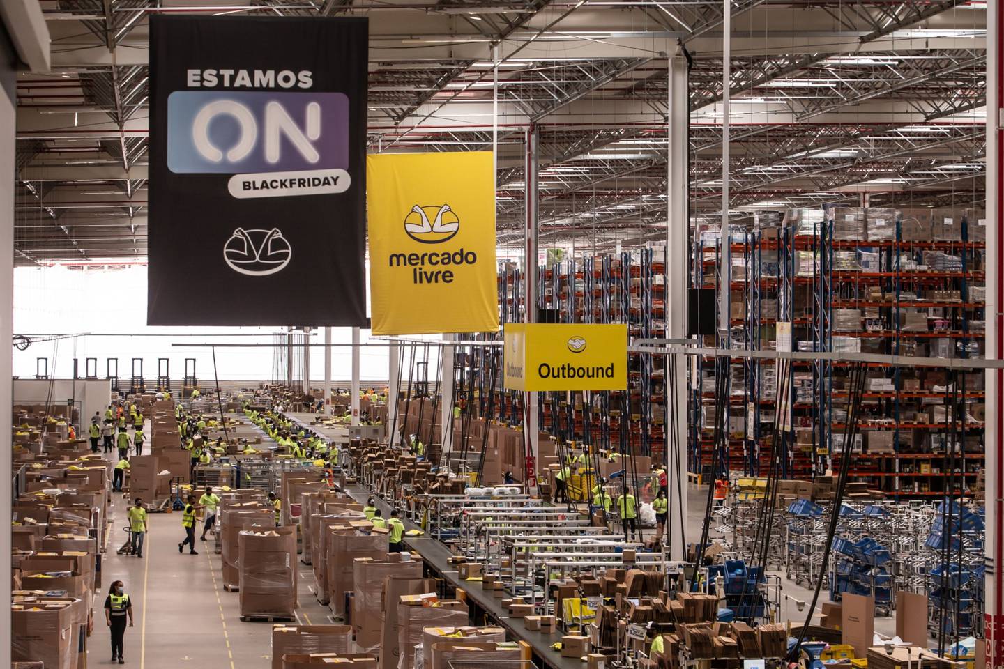 Workers walk through a MercadoLibre Inc. distribution and fulfillment center in Cajamar-SP, Brazil, on Friday, Nov. 27, 2020.