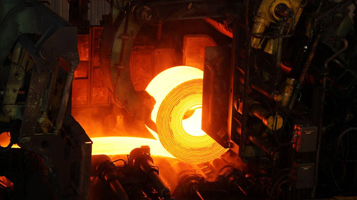 Red-hot rolled steel coil is run through the rollers in Espirito Santo, Brazil.