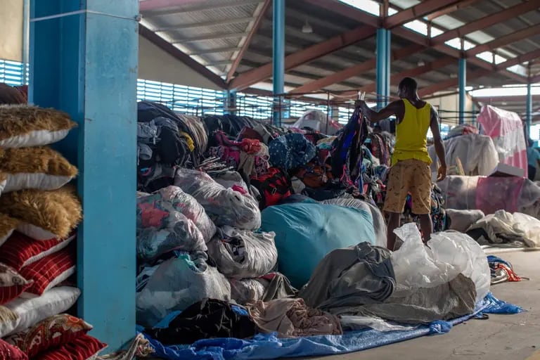 A Haitian merchant organizes textiles to sell at the Dajabón Border Market.dfd