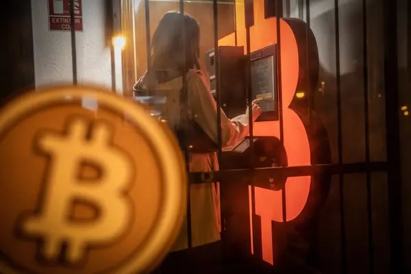 A customer uses a bitcoin automated teller machine in a kiosk in Barcelona. Photographer: Angel Garcia/Bloomberg