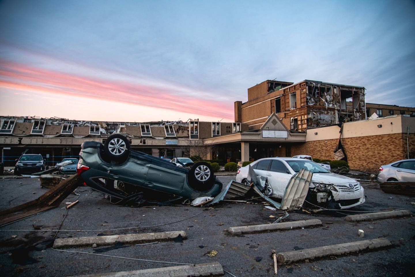 Damaged vehicles and buildings following a tornado on Dec. 11.