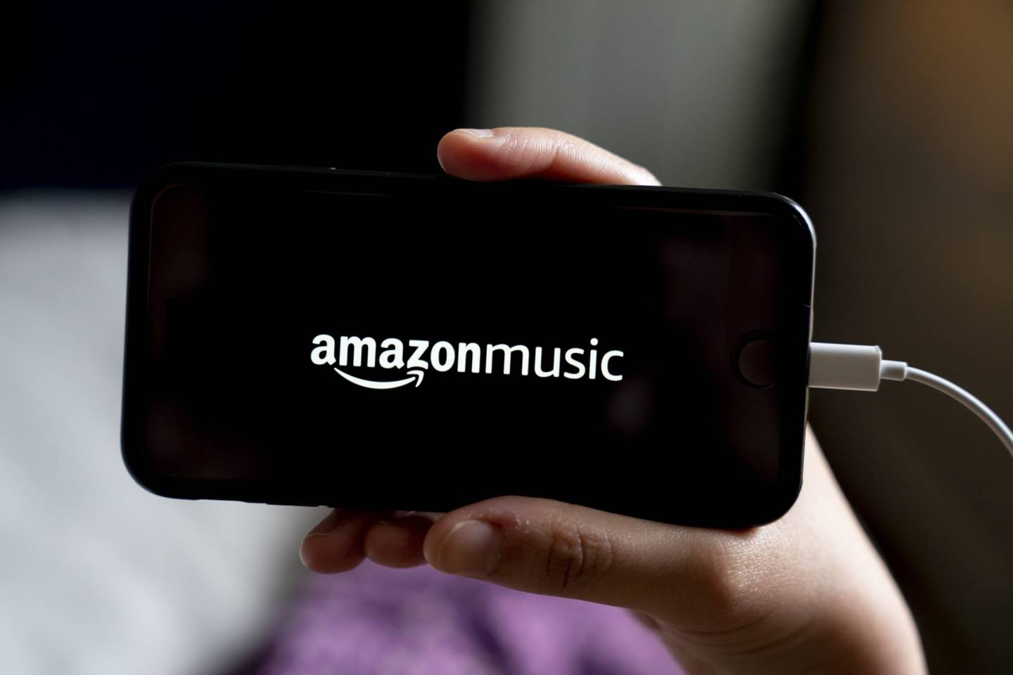 The logo for Amazon Music is displayed on a smartphone in an arranged photograph taken in Arlington, Virginia, U.S., on Thursday, May 21, 2020. Audible's, the audiobook service owned by Amazon.com Inc., big push into the booming audio genre has confused some producers and podcast networks because it is happening at the same time that Amazon Music, a separate division of the e-commerce giant, is also ramping up its investment in podcasts. Photographer: Andrew Harrer/Bloomberg