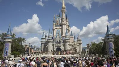 Visitors watch a performance at the Cinderella Castle at the Walt Disney Co. Magic Kingdom park in Orlando, Florida, U.S., on Tuesday, Sept. 12, 2017. The Walt Disney Co. Magic Kingdom park reopened to a smaller-than-usual crowd after closing for two days and suffering minor storm damage from Hurricane Irma.