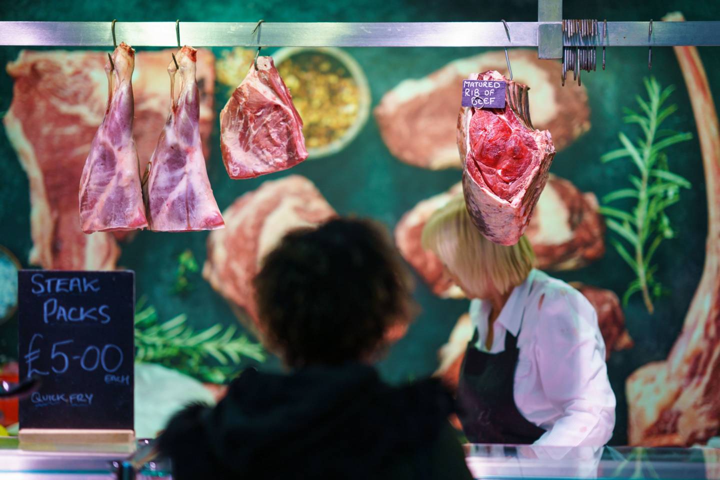 A customer shops at a butcher's stall in Sheffield, UK.dfd
