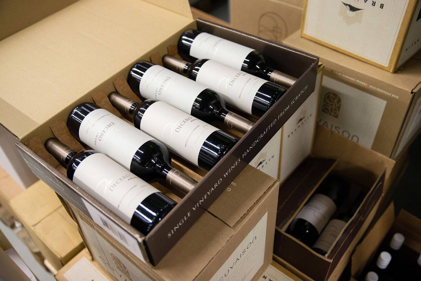 Bottles of red wine sit in a cardboard delivery case ahead of shipping at the Schmidheiny Weingut, in Heerbrugg, Switzerland.