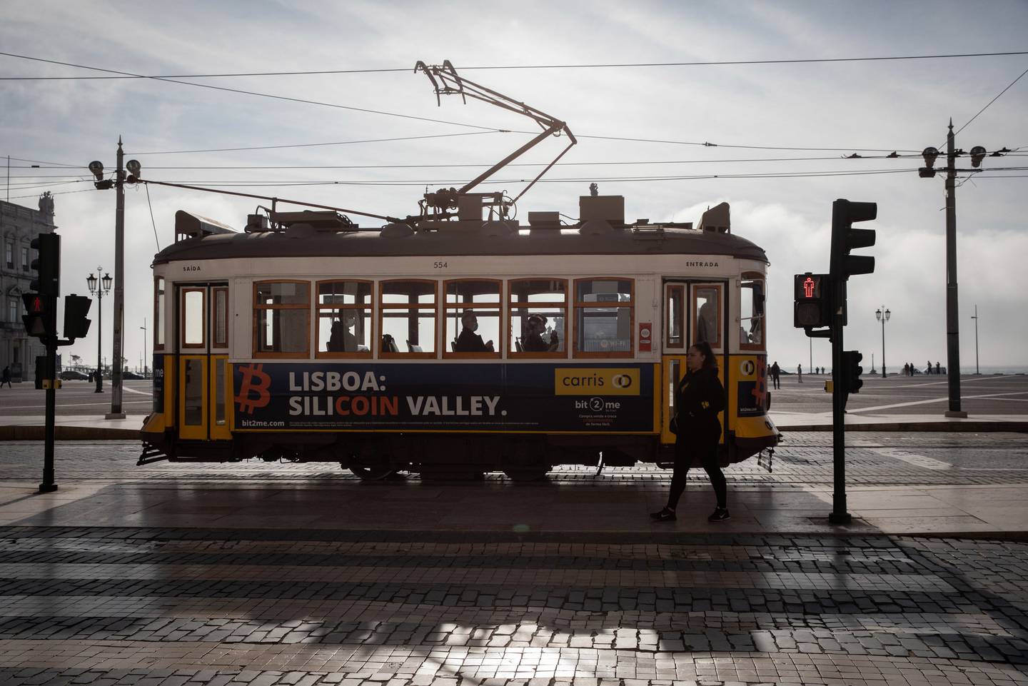 An electric tram passes a street crossing in Lisbon, Portugal, on Tuesday, Jan. 11, 2022.