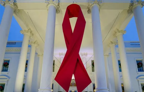 A large red ribbon is seen on the White House to mark World AIDS Day in Washington, DC.