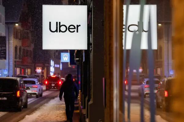 A sign with the Uber Technologies Inc. logo at their pavilion ahead of the World Economic Forum (WEF) in Davos, Switzerland, on Sunday, Jan. 15, 2023. The annual Davos gathering of political leaders, top executives and celebrities runs from January 16 to 20. Photographer: Stefan Wermuth/Bloomberg