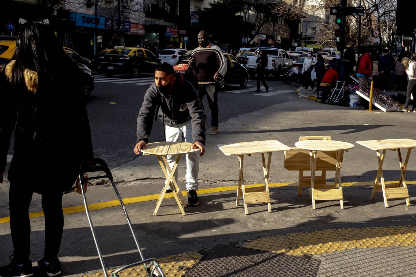 A street vendor sells tables on Corrientes Avenue in the Balvanera neighborhood of Buenos Aires, Argentina.