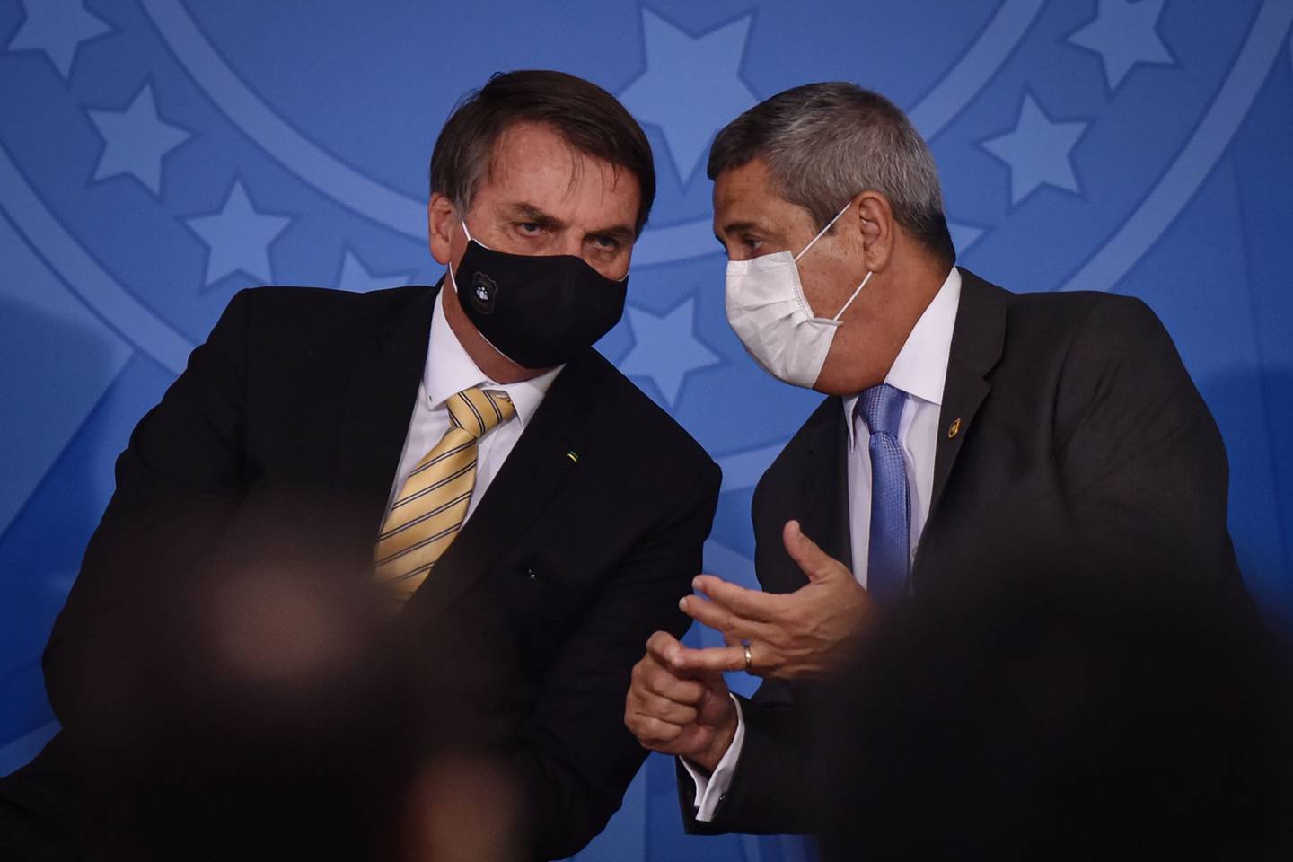 Jair Bolsonaro, presidente de Brasil, a la izquierda, y Walter Braga Netto, jefe de gabinete de Brasil, llevan una máscara protectora mientras hablan durante un evento en el Palacio de Planalto en Brasilia, Brasil, el viernes 15 de mayo de 2020.dfd