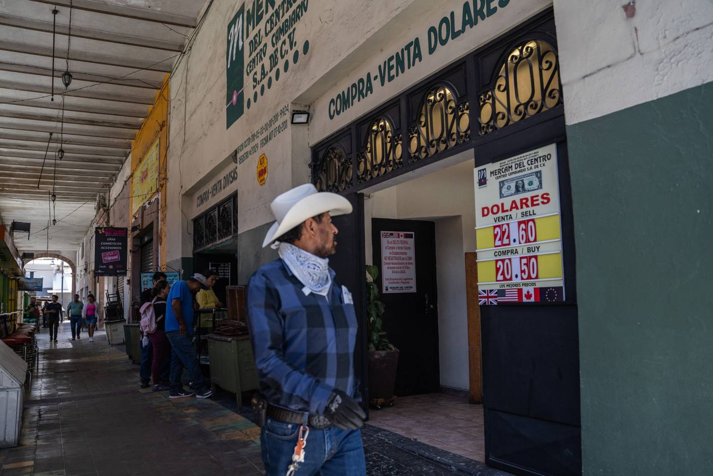 Pedestrians walk past a currency exchange location in San Luis Potosi, Mexico.