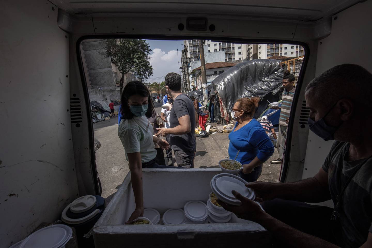 Members of the State Movement for the Homeless Population hand out food donations in Sao Paulo.dfd