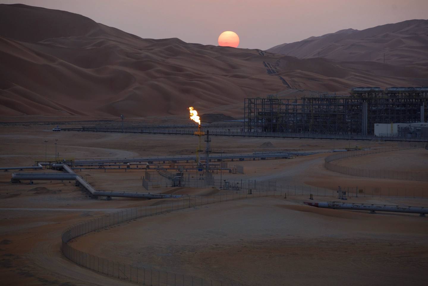 A flame burns from a stack at the oil processing facility at Saudi Aramco's Shaybah oil field in the Rub' Al-Khali desert, also known as the 'Empty Quarter,' in Shaybah, Saudi Arabia, on Tuesday, Oct. 2, 2018. Saudi Arabia is seeking to transform its crude-dependent economy by developing new industries, and is pushing into petrochemicals as a way to earn more from its energy deposits. Photographer: Simon Dawson/Bloomberg