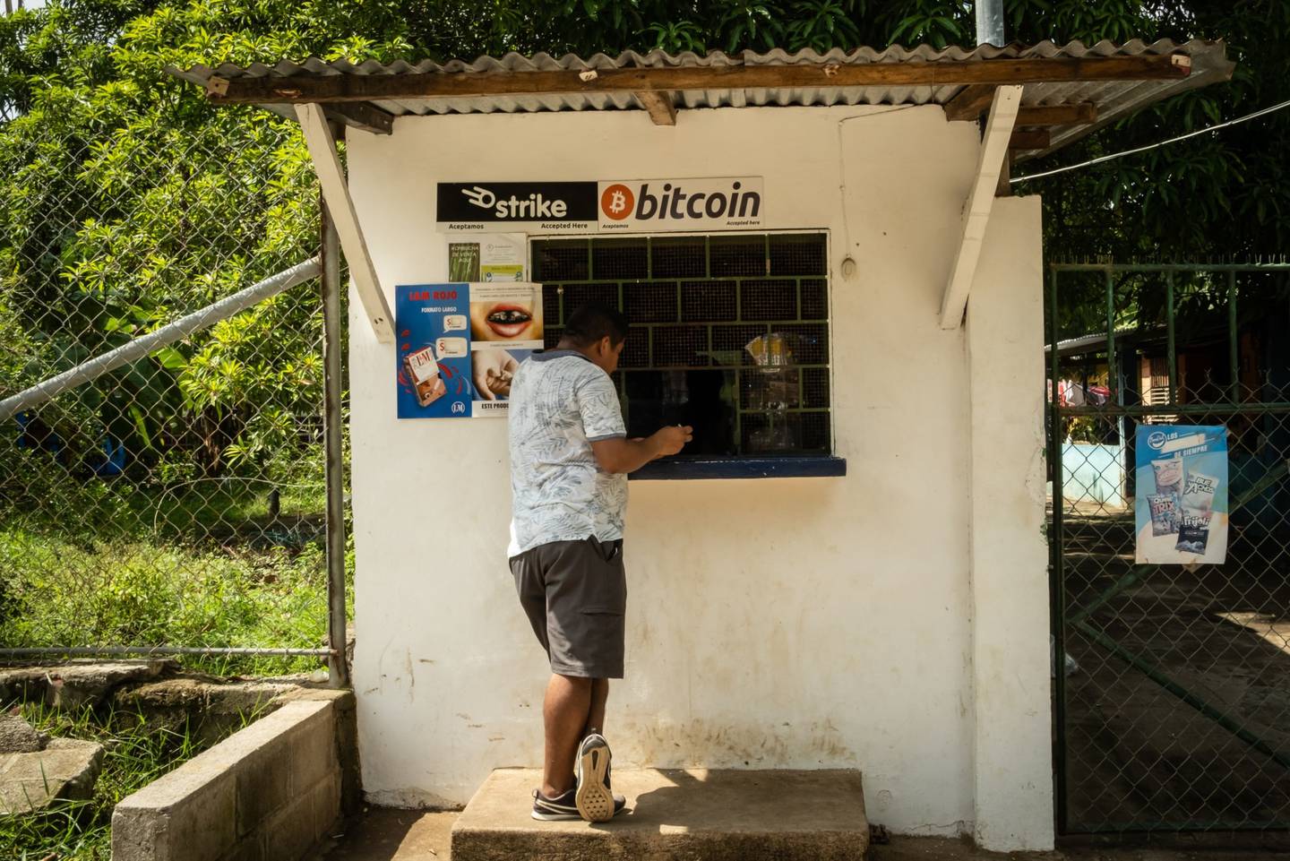 Una persona compra una botella de Coca-Cola en una tienda que acepta Bitcoin en El Zonte, El Salvador, el lunes 14 de junio de 2021. El Salvador se ha convertido en el primer país en adoptar formalmente el Bitcoin como moneda de curso legal después de que el presidente Nayib Bukele dijera que el congreso aprobó su histórica propuesta.